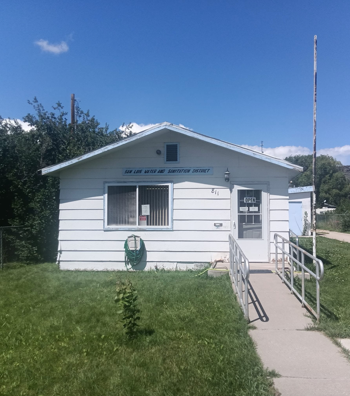 A small white building with a wheelchair ramp
